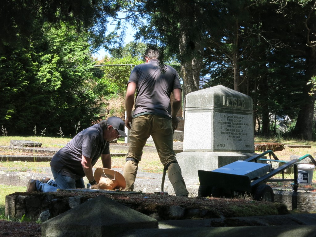 Brad and Carl of Meadowlark Memorials placing Sarah Schultz' new marker stone